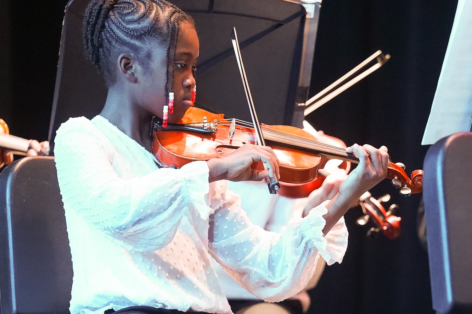 String Orchestra violinist performing in concert